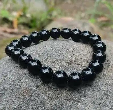 Natural black obsidian bracelet with polished AAA grade beads strung on an elastic cord.