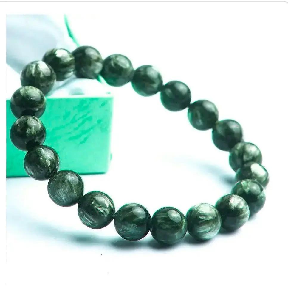 Seraphinite gemstone bracelet with polished green beads displayed on a neutral background for clear viewing.