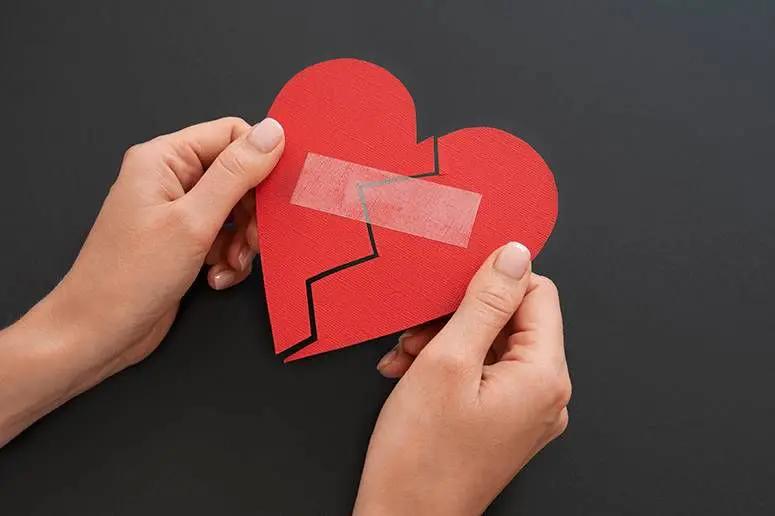 Broken heart pieces joined together representing relationship healing and session booking.