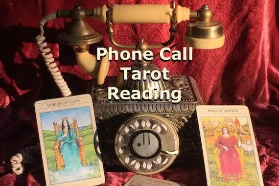 Tarot cards arranged on a table for a remote phone consultation and spiritual guidance session.