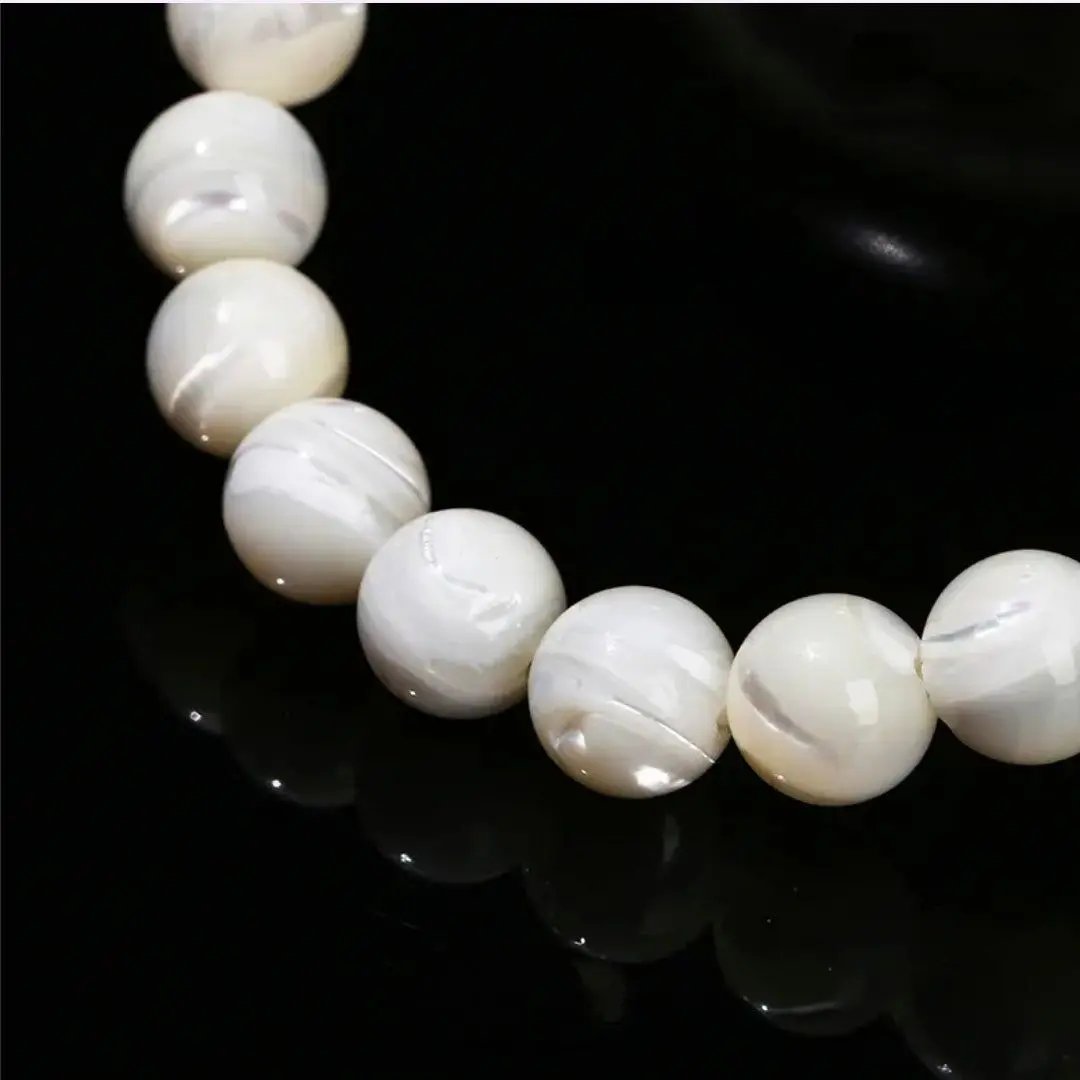 Troshus ocean shell pearls bracelet displayed on a neutral surface for casual everyday wrist styling