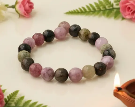 Multi color tourmaline crystal bracelet displayed on a neutral background for clear product viewing.