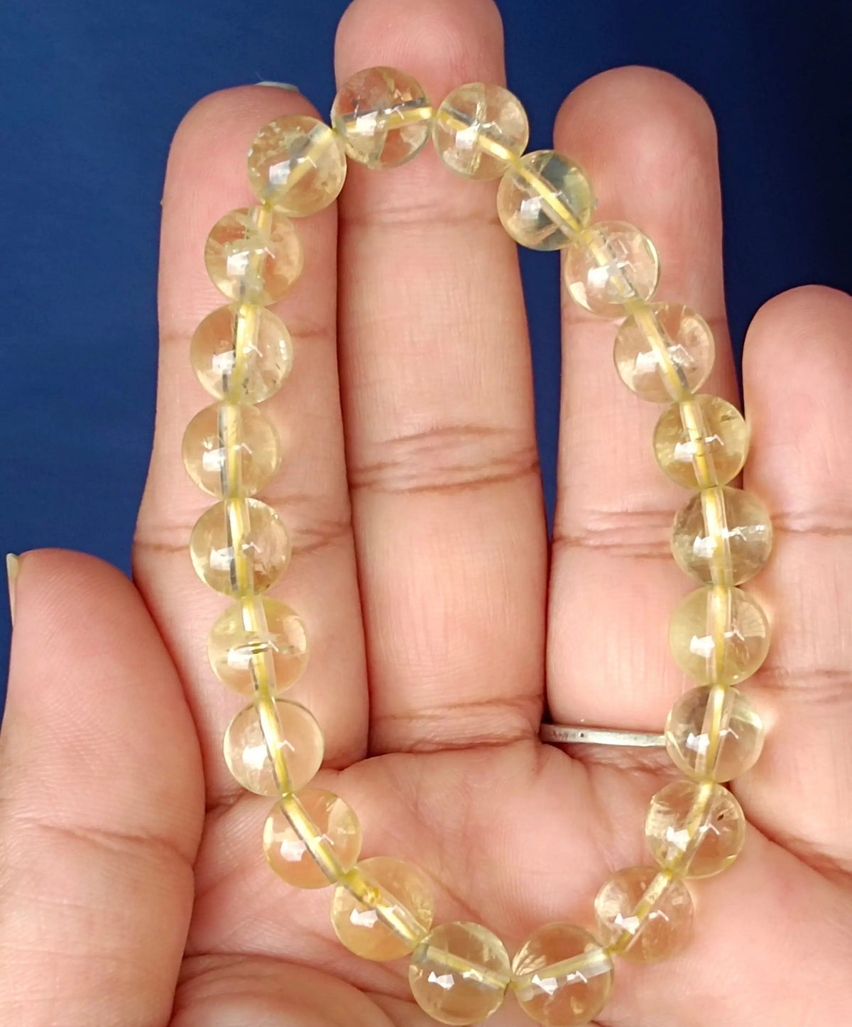 Lemon quartz beaded bracelet displayed flat on a neutral surface for daily styling.
