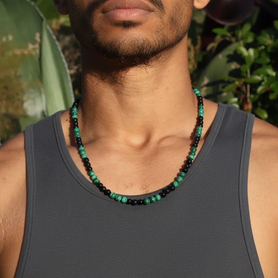 Green malachite and black obsidian beads strung on a simple chain necklace