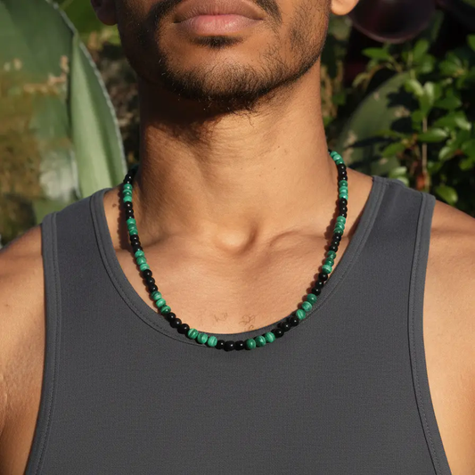 Green malachite and black obsidian beads strung on a simple chain necklace