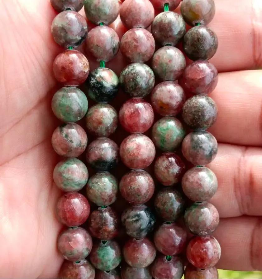 Polished grossular garnet bracelet arranged on a flat surface for daily wrist accessory styling.