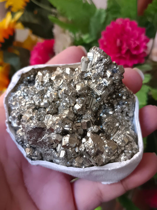 Natural Peruvian pyrite crystal specimen displayed for meditation and holistic wellness practices.