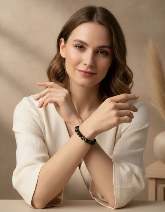 Golden obsidian bracelet featuring polished beads on an elastic cord for daily wear.