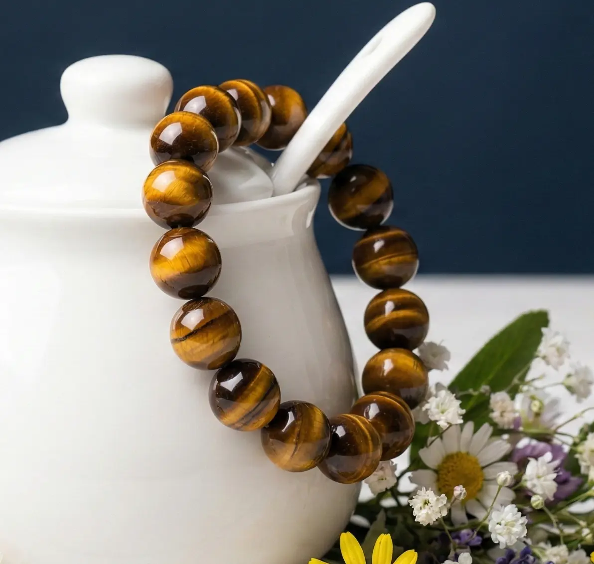 Polished tiger eye stone beads threaded on an elastic cord forming a wrist bracelet.