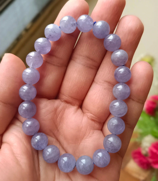 Tanzanite bracelet featuring blue violet gemstones arranged on a neutral background for jewelry display.