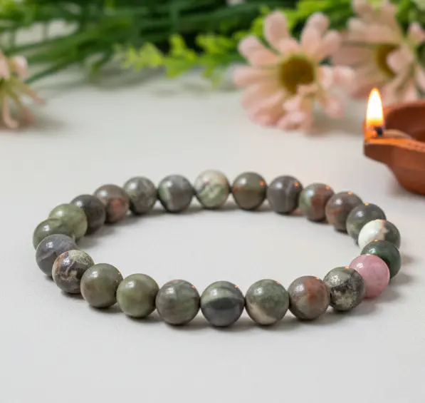 Polished rainforest rhyolite jasper gemstone showing natural green and brown earthy mineral formations