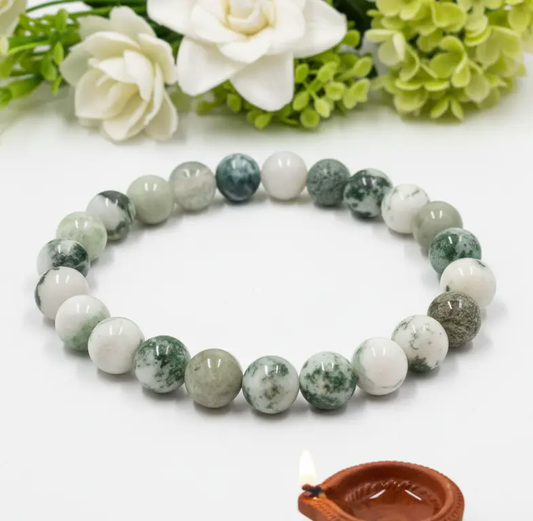 Natural tree agate stone showing green moss-like patterns used for grounding and stability.