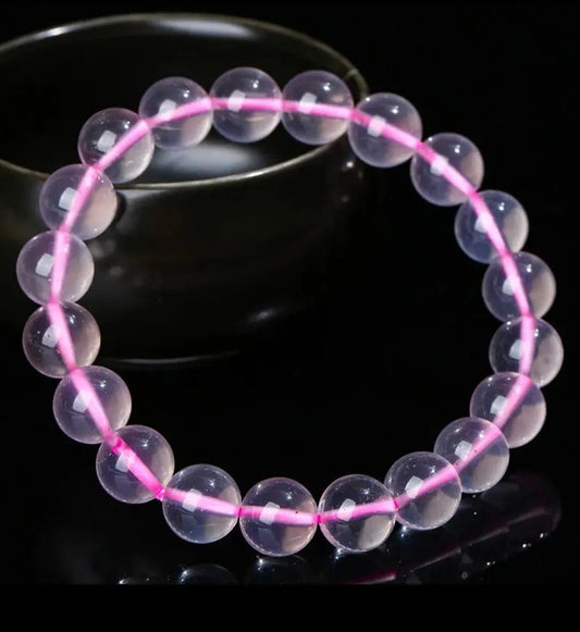 Mozambique rose quartz beaded bracelet arranged on a plain surface for everyday wear.