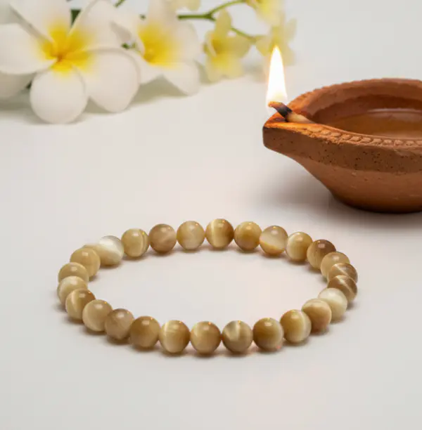 Golden tiger eye beaded bracelet displayed on a neutral background highlighting natural stone patterns