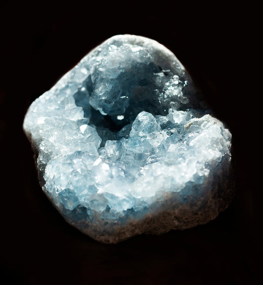 Close up photograph of a floating blue crystal illustrating natural metaphysical properties and energy.