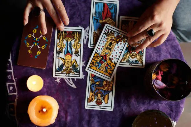 A spread of online tarot reading cards arranged on a flat surface for virtual divination sessions