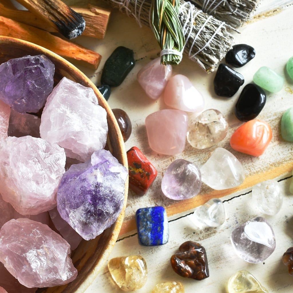 Display of crystal polished tumbles and rough crystals arranged on a neutral background for home decor
