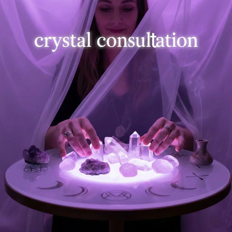 Assorted natural crystals arranged on a wooden surface for a personal crystal consultation.
