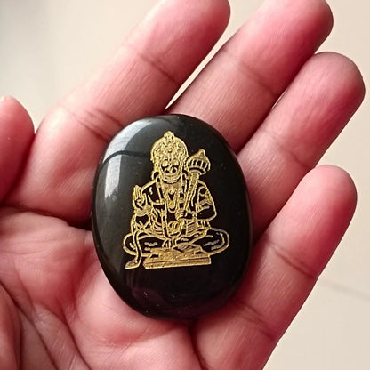 Front view of a divine shield coin showing protective engravings on a clean background.