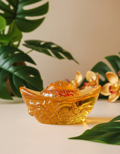 Decorative wealth ingot ornament displayed for prosperity rituals and holistic home decoration